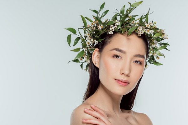 Beautiful asian lady with a crown of flowers and leaves