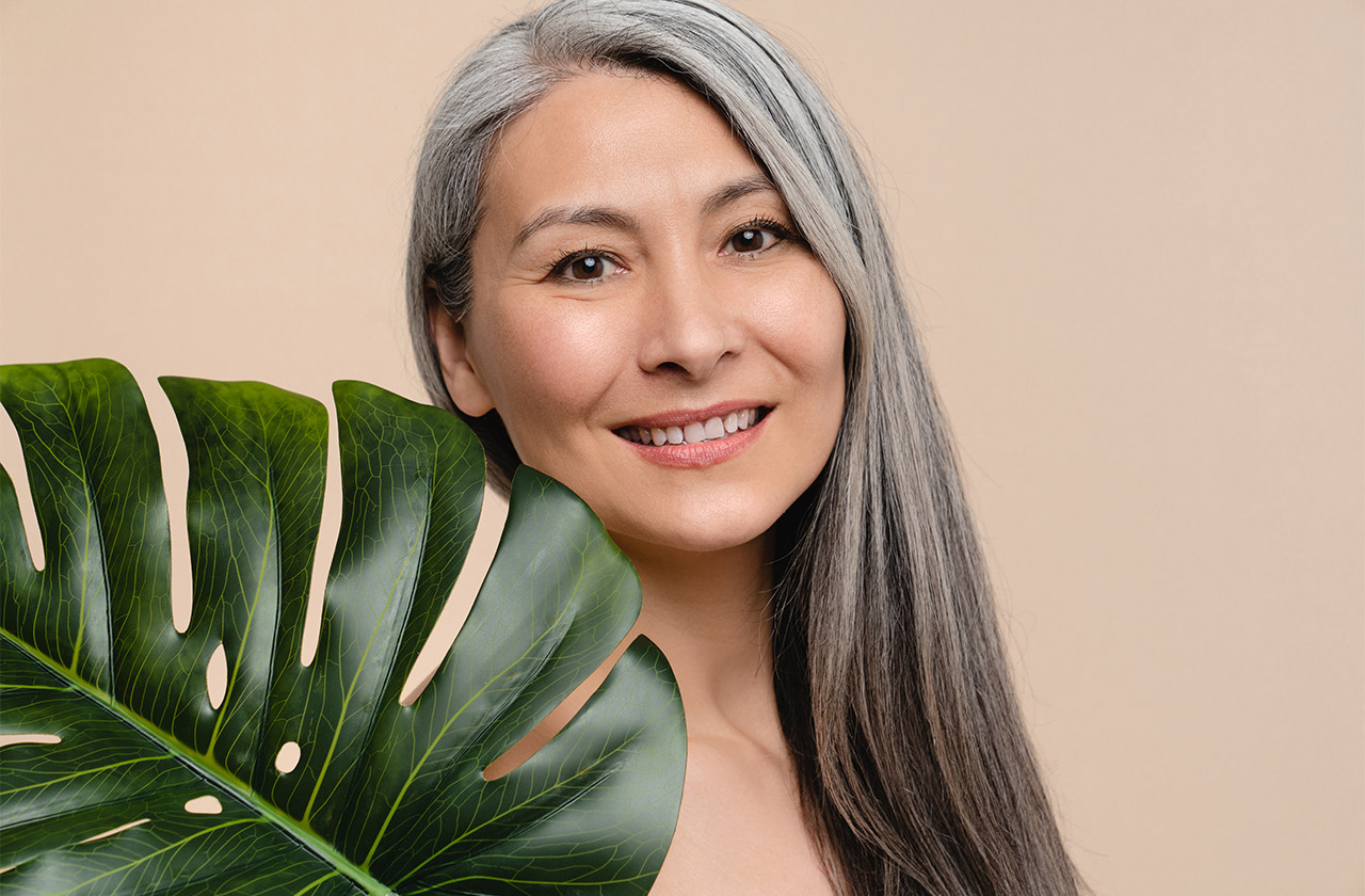 Beautiful older lady with palm leaf